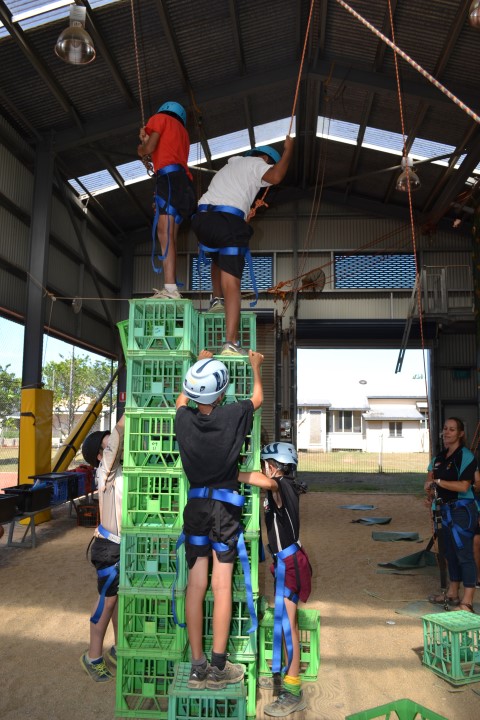 students climbing on a crate structure