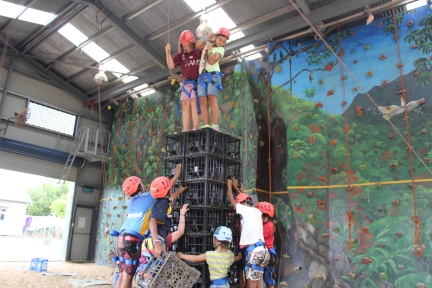 students climbing on crate structure