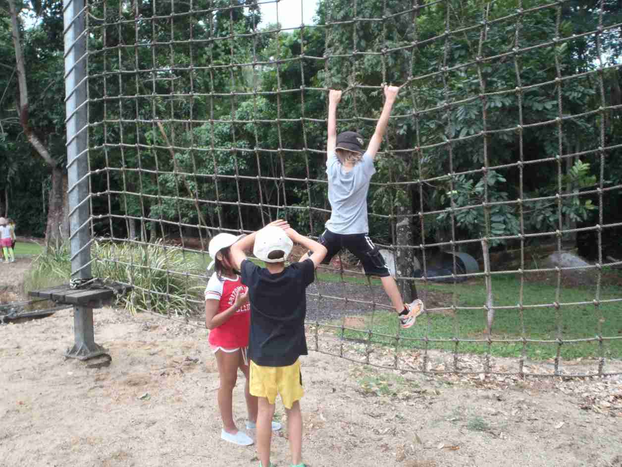 students climbing net